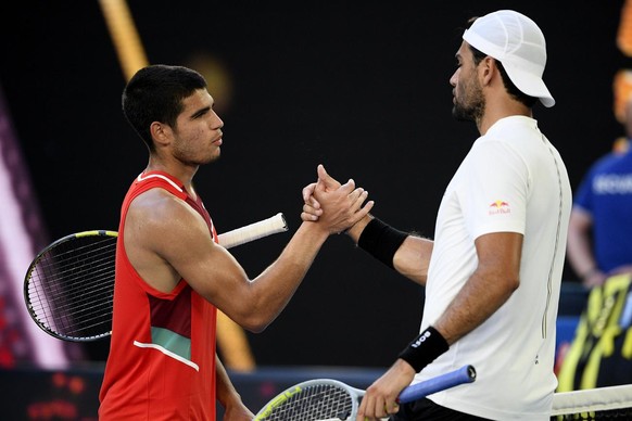 Matteo Berrettini, right, of Italy is congratulated by Carlos Alcaraz, left, of Spain after winning their third round match at the Australian Open tennis championships in Melbourne, Australia, Friday, ...