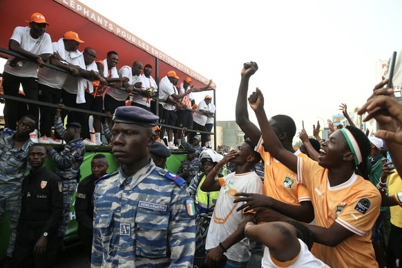 epa11148429 The Ivory Coast national football team waves to the crowd atop a bus as part of the trophy parade, in Abidjan, Ivory Coast, 12 February 2024. Ivory Coast on 11 February won the CAF 2023 Af ...