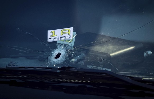 A bullet hole is seen in the windshield of an RCMP vehicle approximately 4 km from Vancouver International Airport after a one person was killed during a shooting outside the international departures  ...