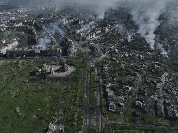 Smoke rises from buildings in this aerial view of Bakhmut, the site of the heaviest battles with the Russian troops in the Donetsk region, Ukraine, Wednesday, April 26, 2023. (AP Photo/Libkos)