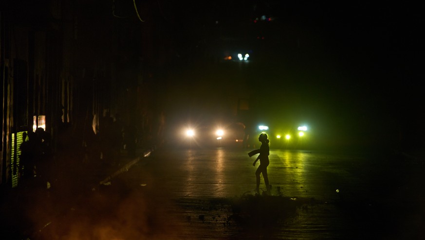 A woman walks in front of a barricade set up by residents protesting against prolonged power outages in Havana, Cuba, Wednesday, May 13, 2026. (AP Photo/Ramon Espinosa)
Cuba Energy Crisis