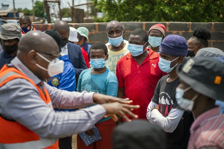 Residents listen to Gauteng Province Premier David Makhura in Lawley, South Africa, Friday Dec. 3, 2021 for the launch of the Vooma vaccination program against COVID-19. South Africa has accelerated i ...