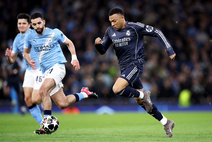 epa12828670 Rayan Aït-Nouri (L) of Manchester City in action against Kylian Mbappe of Real Madrid during the UEFA Champions League Round of 16 2nd leg match between Manchester City and Real Madrid in  ...