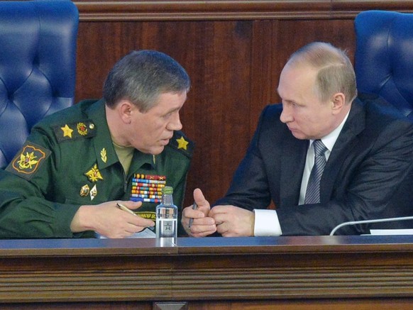 epa05065110 Russian President Vladimir Putin (R) talks with the Chief of Russian army general staff Valery Gerasimov (L), during Defence Ministry board meeting in Moscow, Russia, 11 December 2015. EPA ...