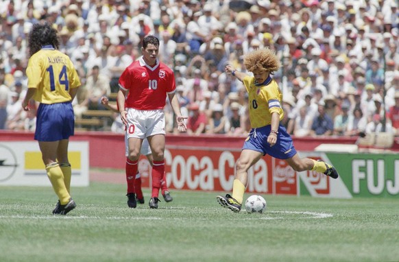 Colombian Carlos Valderrama, right dribbles past Ciriaco Sforza of Switzerland during the Group A World Cup first round match Switzerland Vs Colombia at Stanford Stadium, Stanford, Calif., on Sunday,  ...
