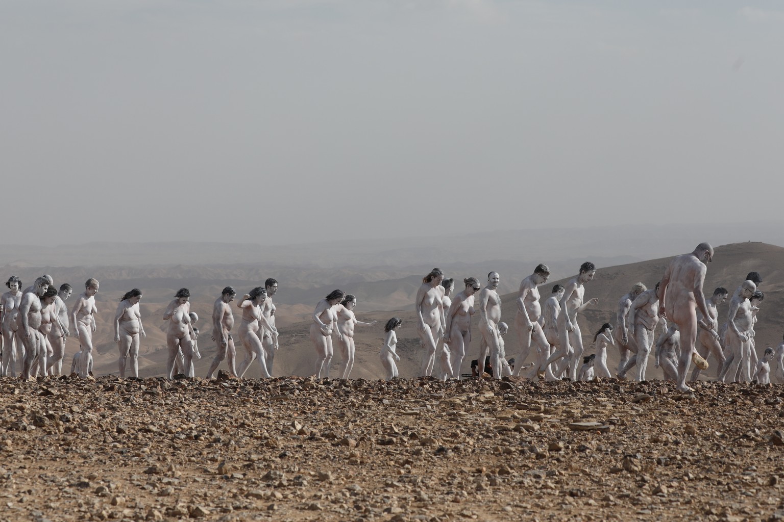 epa09528513 Nude participants take part in a photo installation of US artist Spencer Tunick (unseen) overlooking the Dead Sea near the southern city of Arad, Israel, 17 October 2021. Some 300 particip ...