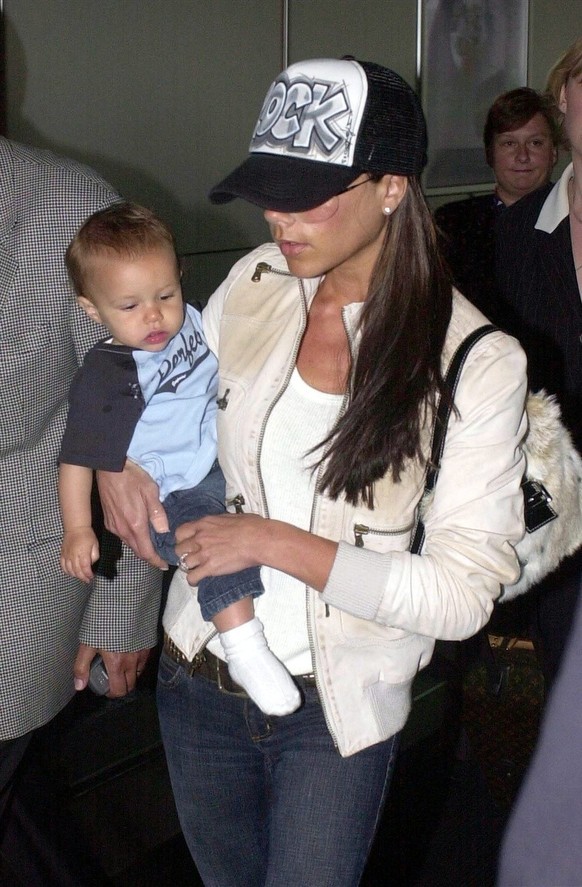 Victoria Beckham with baby Romeo wife and son of England and Manchester United footballer David Beckham arrives with his family at Heathrow Airport, London, Saturday14 June 2003, after their holiday i ...
