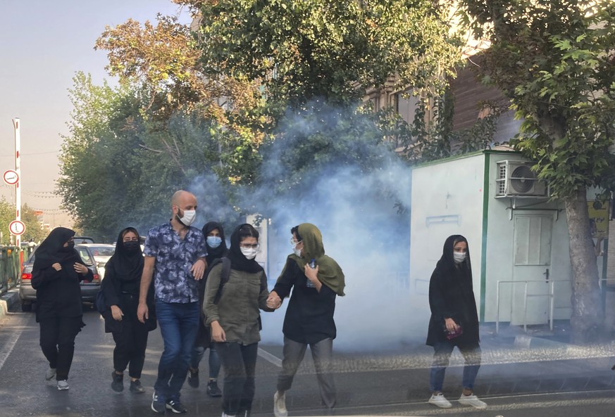 FILE - In this Saturday, Oct. 1, 2022, photo taken by an individual not employed by the Associated Press and obtained by the AP outside Iran, tear gas is fired by security to disperse protestors in fr ...
