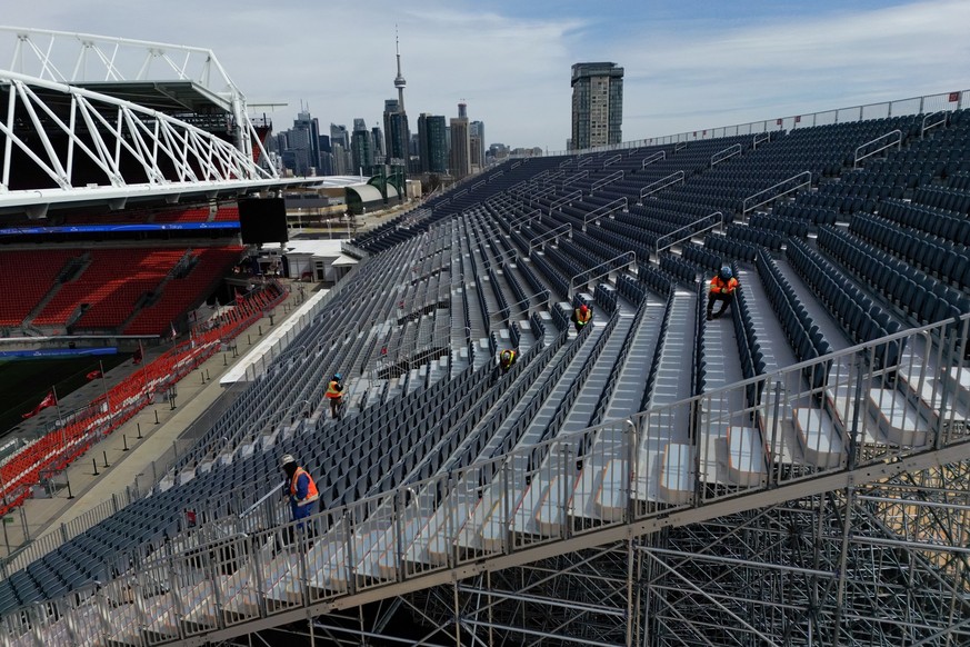 Workers are seen assembling temporary bleacher seating to add extra capacity near the regular stands at BMO Field in Toronto, Canada on March 24, 2026, ahead of the upcoming FIFA World Cup. BMO Field  ...