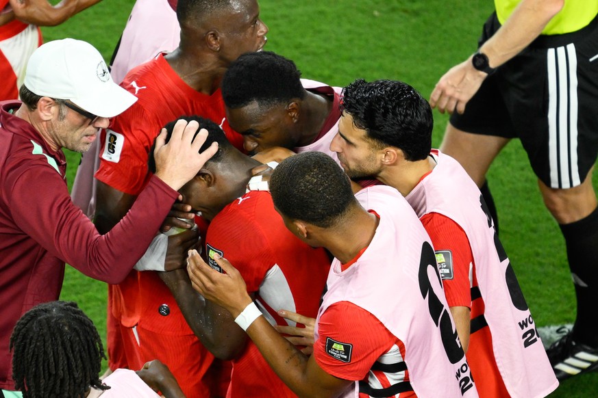 Teammates comfort Switzerland's Breel Embolo (7) after he was issued a second yellow card during the World Cup quarterfinal soccer match against Argentina in Kansas City, Mo., Saturday, July 11,  ...