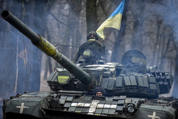 epa10413479 A Ukrainian T-72 tank manoeuvers through the trees in the Donetsk region, eastern Ukraine, 18 January 2023. Britain?s defence secretary Ben Wallace confirmed on Monday that the UK would se ...