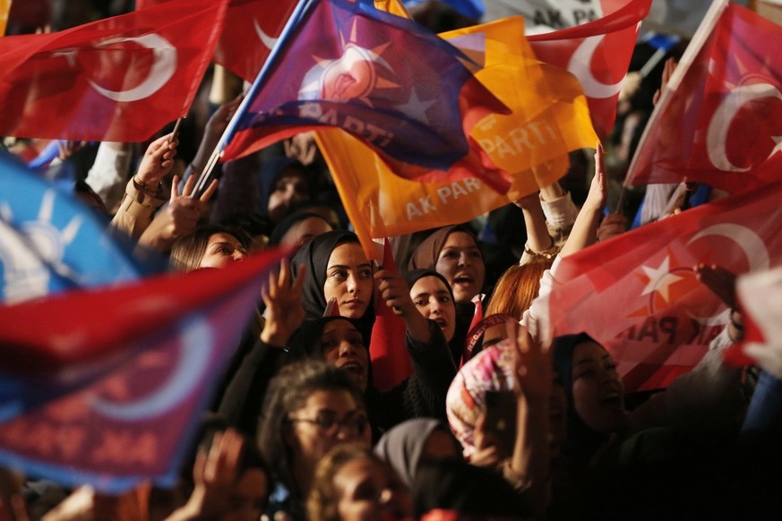 epa10628791 Supporters wave flags and banners as Turkish President and presidential candidate Recep Tayyip Erdogan makes an address at the Justice and Development Party (AKP) headquarters, in Ankara,  ...