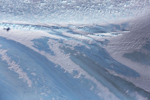 UNSPECIFIED, ANTARCTICA - OCTOBER 31: The shadow of NASA&#039;s Operation IceBridge research aircraft (L) is cast over blue ice, in the Antarctic Peninsula region, on October 31, 2017, above Antarctic ...