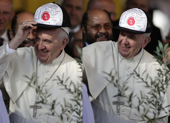 Pope Francis puts on a cap of "Scholas Ocurrentes" signed by students at the end of a ceremony at the Banado Norte neighbourhood in Asuncion, Paraguay, Sunday, July 12, 2015. "Scholas O ...