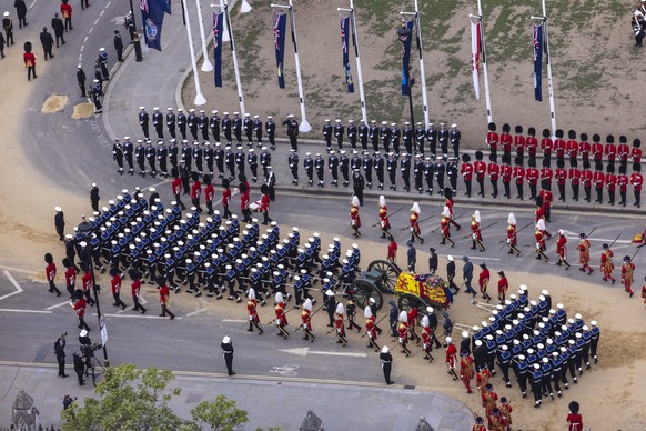 epa10193193 A handout picture provided by the British Ministry of Defence (MoD) shows the coffin of late Queen Elizabeth II being pulled by Royal Navy sailors during the State Funeral Procession of Qu ...