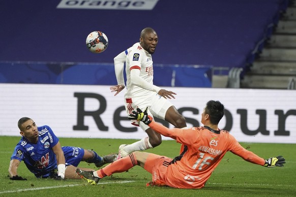 Lyon&#039;s Karl Toko Ekambi, center, scores a goal against Strasbourg during the French League One soccer match between Lyon and Strasbourg, in Decines, near Lyon, central France, Saturday, Feb. 6, 2 ...