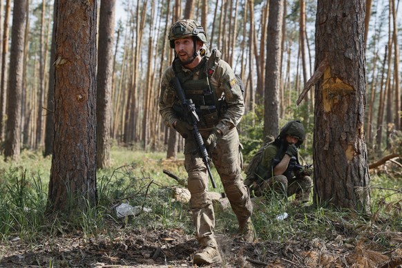 Ukrainian soldiers works during a combat operation on the frontline near Kreminna, Luhansk region, Ukraine, Thursday, June 8, 2023. (Roman Chop via AP)
