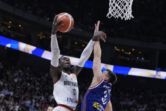 Germany guard Dennis Schroder (17) shoots in front of Serbia guard Aleksa Avramovic (30) during the championship game of the Basketball World Cup in Manila, Philippines, Sunday, Sept. 10, 2023. (AP Ph ...