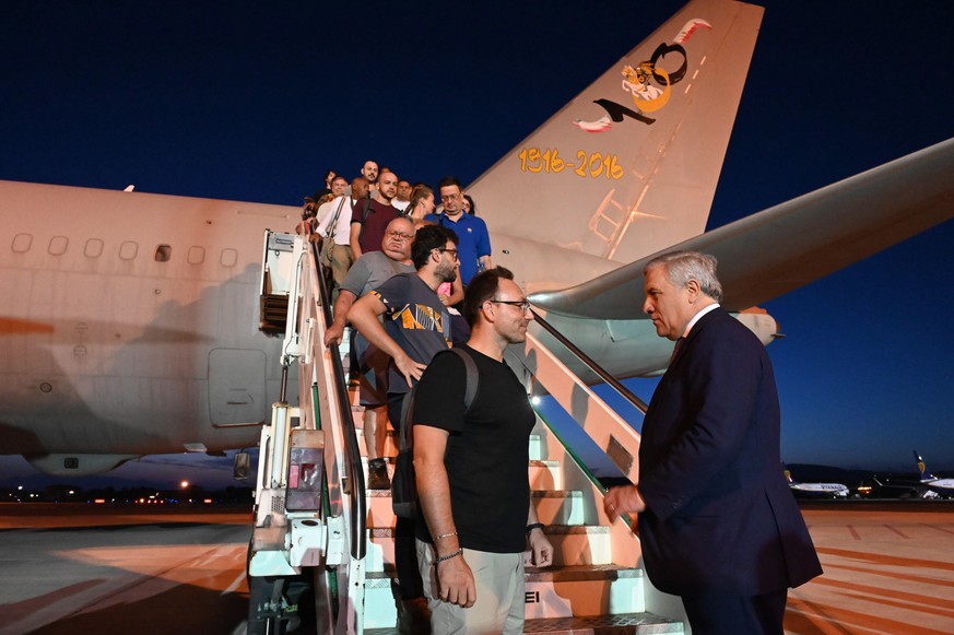 epa10780858 Italian Foreign Minister Antonio Tajani (R) greets passengers from a plane which left from Niger just before midnight, at Ciampino International Airport in Ciampino (Rome), Italy, 02 Augus ...