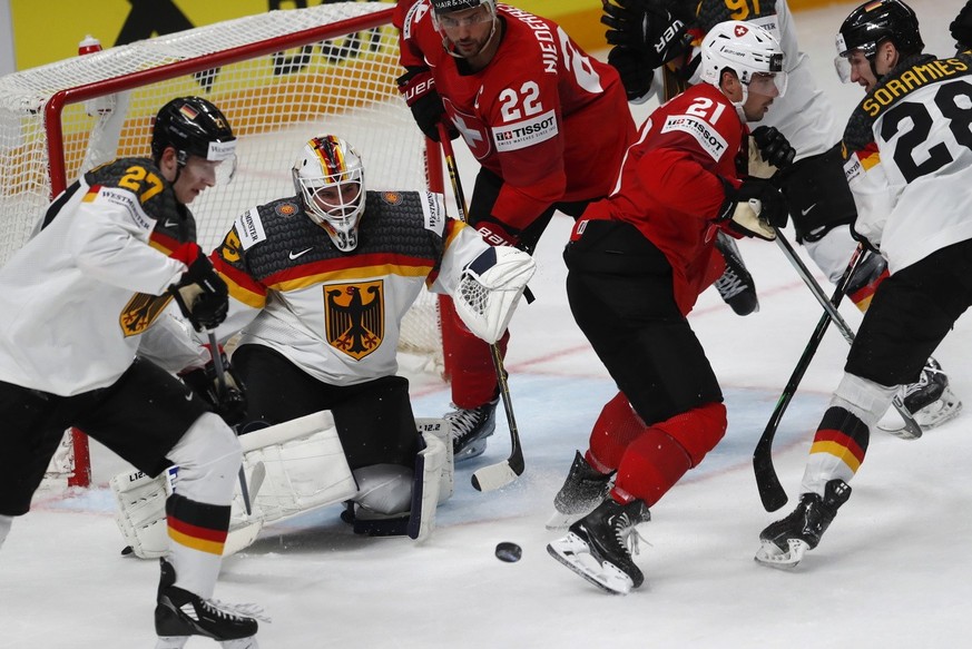 epa10653056 Kevin Fiala (2nd R), Nino Niederreiter (C) of Switzerland in action with goaltender Mathias Niederberger, Maksymilian Szuber (L), Samuel Soramies (R) of Germany during the quarter final ma ...