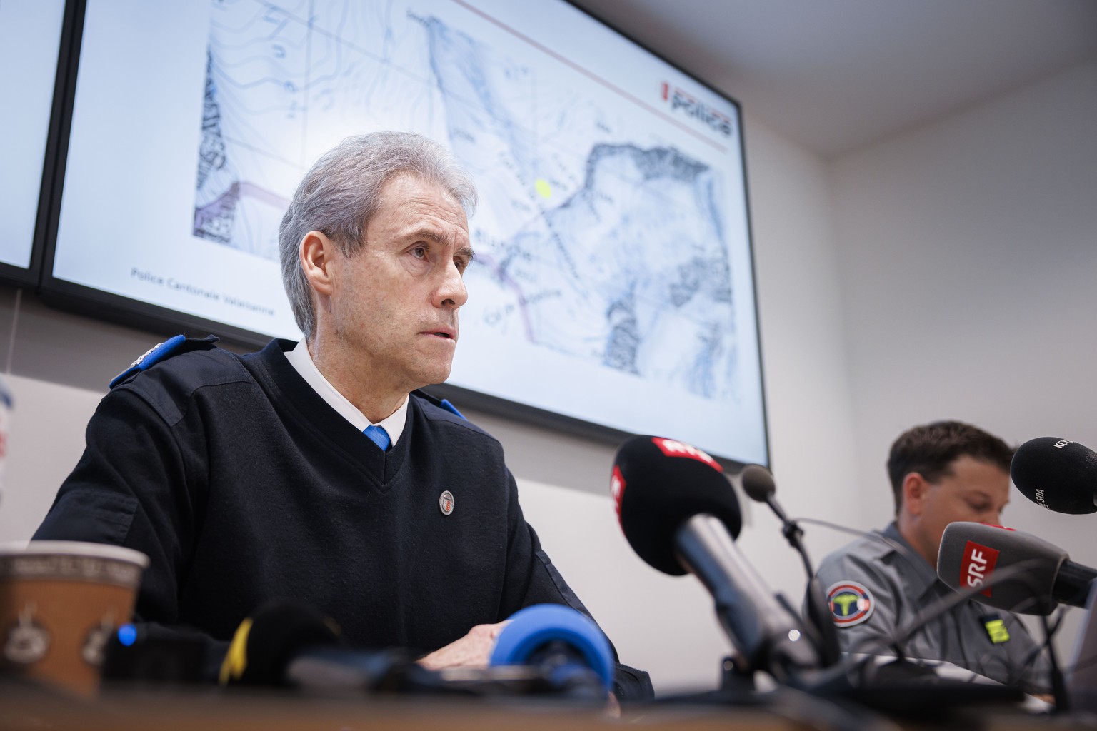 epa11213717 Commandant of the Valais Cantonal Police Christian Varone (L) speaks during a press conference following the discovery of five ski tourers, who had died near Tete Blanche in the Swiss alps ...