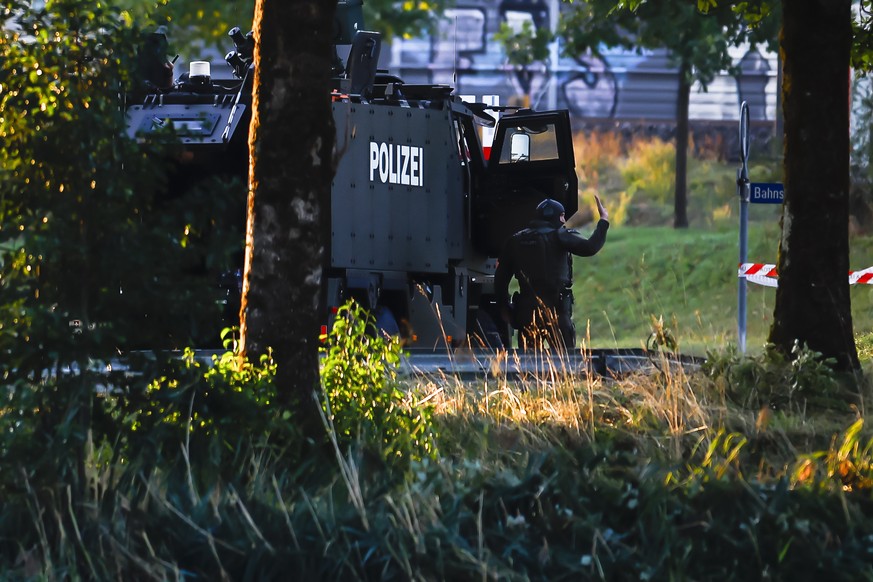 Armed police officers with an armored special-purpose vehicle block a street near the Schachen horse racing track in Aarau following a shooting during a rave event at the Schachen horse racing track n ...