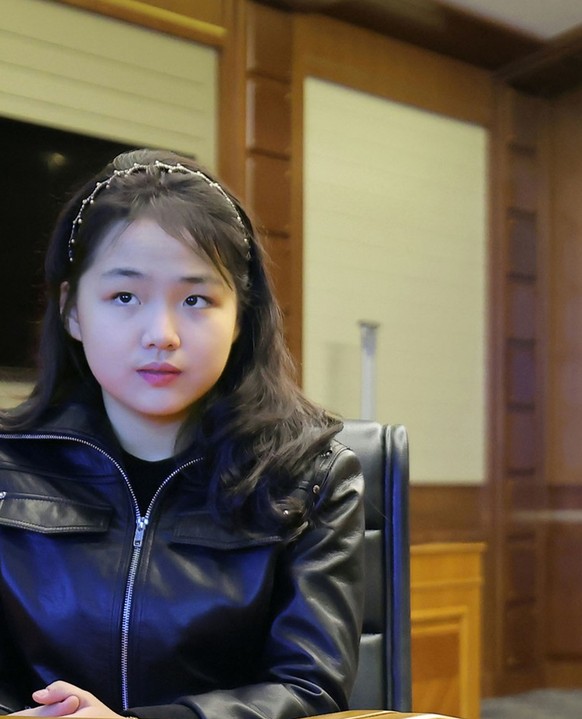 This photo provided by the North Korean government shows its leader Kim Jong Un, right, and his daughter, left, watch what it says the cruise missiles launches from the naval destroyer, the Choe Hyon, ...