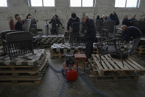 Russian prisoners of war make a garden furniture in a workshop at a detention center for Russian POWs in western Ukraine on November 26, 2025, amid the Russian invasion of Ukraine. Since Russia invade ...