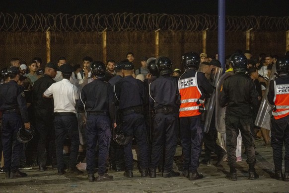 epa13142973 People gather at the Bab Sebta border crossing between Morocco and the Spanish enclave of Ceuta, near Fnideq, Morocco, 30 July 2026. Spain and Morocco agreed to the urgent return of migran ...