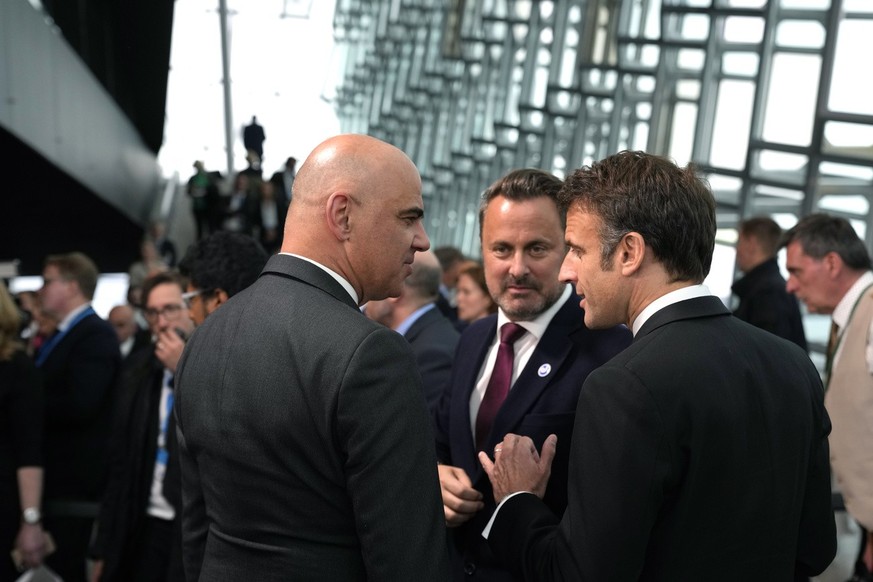 President of the Swiss Confederation Alain Berset, left, speaks with France&#039;s President Emmanuel Macron, right, and Luxembourg&#039;s Prime Minister Xavier Bettel during a group photo at the Coun ...