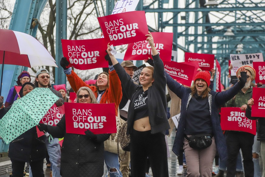 The New Suffragettes and supporters gather at the end of the Walnut Street Bridge during a march in Chattanooga, Tenn., Sunday, Jan. 22, 2023, to commemorate the 50th anniversary of the Roe v Wade dec ...