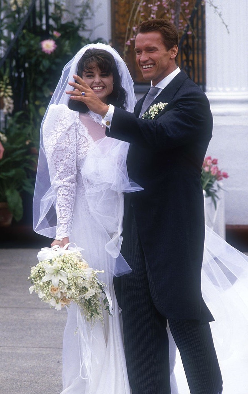 HYANNIS, MA - APRIL 26: Actor Arnold Schwarzenegger with his new wife Maria Shriver outside St. Francis Xavier Church after their wedding on April 26, 1986 in Hyannis, Massachusetts. (Photo by Peter C ...