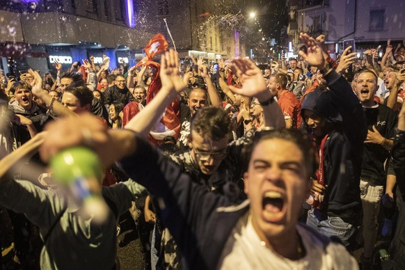 Fans of Switzerland celebrate after the Euro 2020 soccer tournament match between France and Switzerland in Zurich, Switzerland, Monday, June 28, 2021. (KEYSTONE/Ennio Leanza).