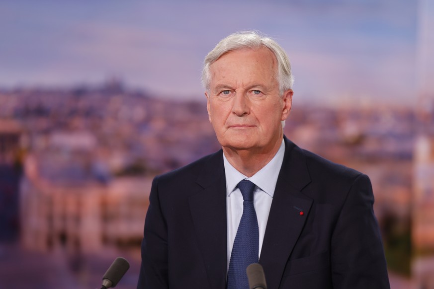 epa11590281 France&#039;s newly appointed Prime Minister, Michel Barnier speaks during the evening news broadcast of French TV channel TF1 with French journalist and TV host Anne-Claire Coudray, in Bo ...