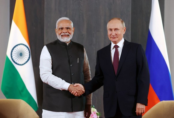 epa10188208 Russian President Vladimir Putin (R) meets with Indian Prime Minister Narendra Modi on the sidelines of the 22nd Shanghai Cooperation Organisation Heads of State Council (SCO-HSC) Summit,  ...