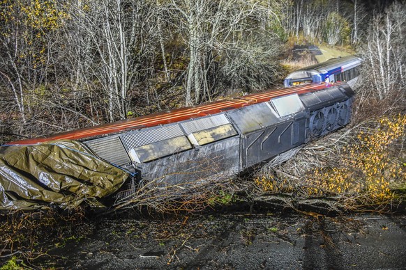 epa11680739 A view of the wrecked train wagons at the site of a derailment in Finneidfjord, Nordland municipality, Norway, on 24 October 2024. According to police, at least one person died and several ...