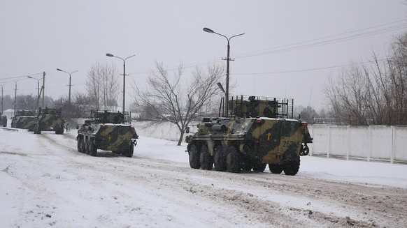 Kharkiv, Ukraine - January, 31, 2022: A column of armored personnel carriers of the Ukrainian army is driving along a snow-covered road. Preparations for the Russian invasion of Ukraine