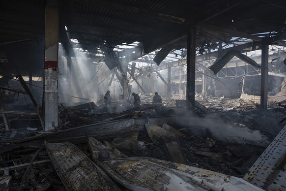 Emergency workers search for victims after a Russian missile hit a supermarket in Kostiantynivka, Donetsk region, Ukraine, Friday, Aug. 9, 2024. (AP Photo/Iryna Rybakova)