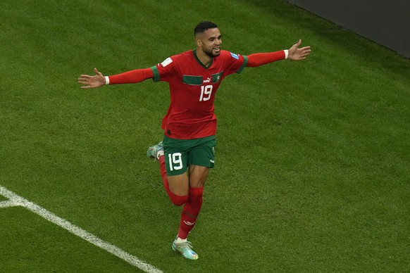 Morocco's Youssef En-Nesyri celebrates after scoring his side's opening goal during the World Cup quarterfinal soccer match between Morocco and Portugal, at Al Thumama Stadium in Doha, Qatar, Saturday ...