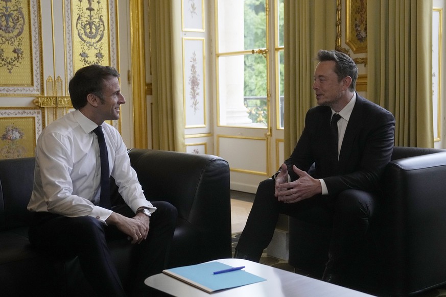 Twitter, now X. Corp, and Tesla CEO Elon Musk, right, poses with French President Emmanuel Macron prior to their talks, Monday, May 15, 2023 at the Elysee Palace in Paris. More than 200 international  ...