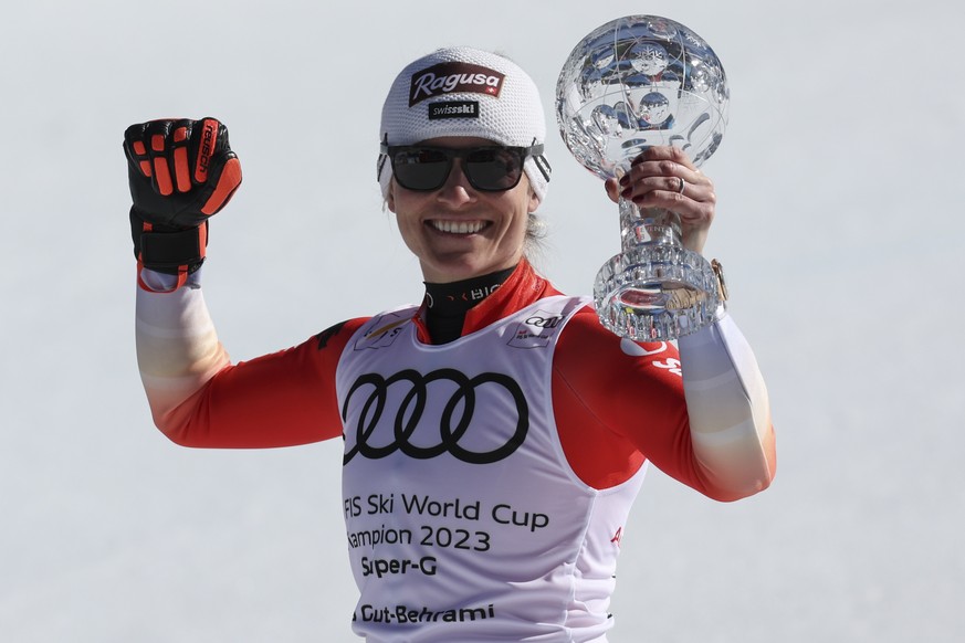 Switzerland's Lara Gut Behrami holds the alpine ski, women's World Cup super-g discipline trophy, in Soldeu, Andorra, Thursday, March 16, 2023. (AP Photo/Alessandro Trovati)
