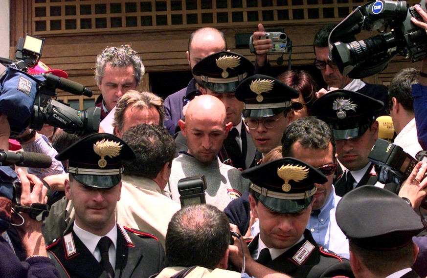 Italy&#039;s Marco Pantani is surrounded by Carabinieri (Italian police) officers as he leaves his hotel in Madonna di Campiglio Saturday, June 5, 1999, after he was banned from the Tour of Italy cycl ...