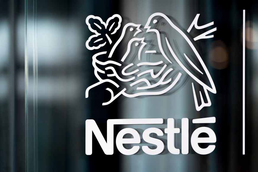 FILE - In this Thursday, Feb. 14, 2019, file photo, Nestle's logo is displayed on a window, during the 2018 full-year results press conference of the food and drinks giant Nestle, in Vevey. (Laur ...