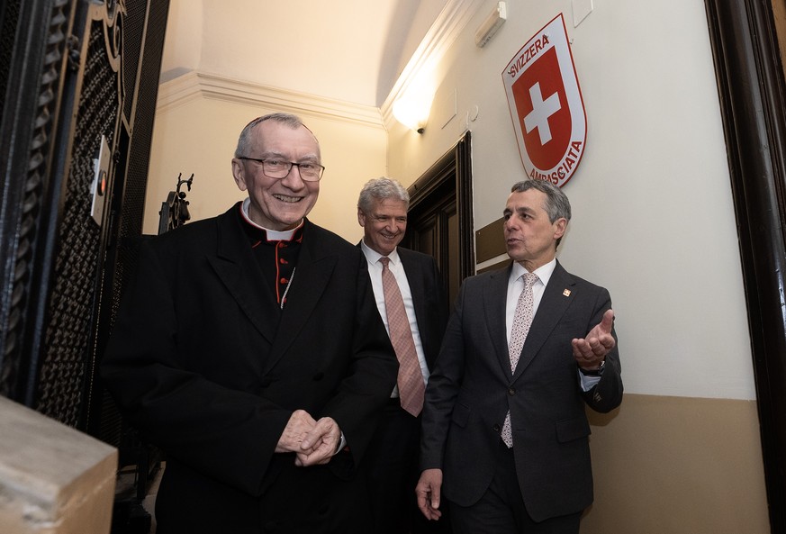 HANDOUT - Swiss Foreign Minister Ignazio Cassis (L), Cardinal Pietro Parolin Secretary of State with States for The Holy See and Denis Knobel Swiss Ambassador arrive for the inauguration of the Swiss  ...