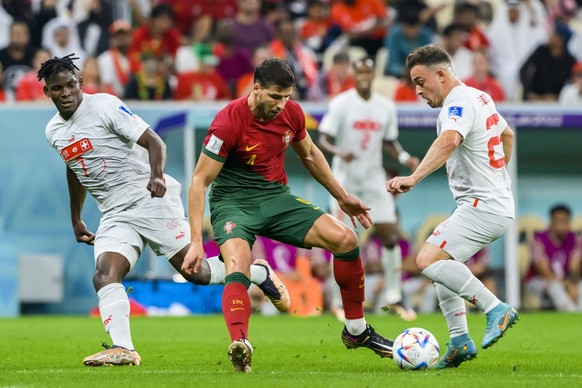 Portugal&#039;s defender Ruben Dias, center, fights for the ball with Switzerland&#039;s forward Breel Embolo, left, and Switzerland&#039;s midfielder Xherdan Shaqiri, right, during the FIFA World Cup ...