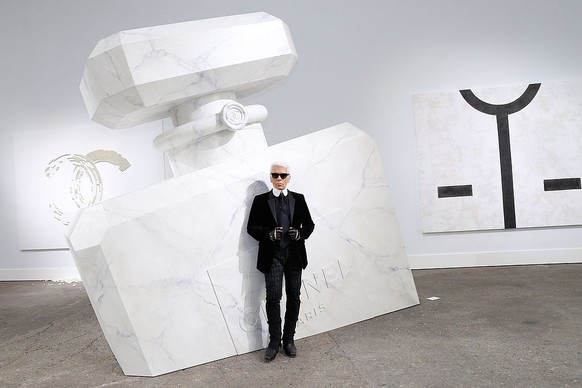 PARIS, FRANCE - OCTOBER 01: (EDITORS NOTE: This image has been retouched) Fashion designer Karl Lagerfeld poses in front of his works before the Chanel show as part of the Paris Fashion Week Womenswea ...