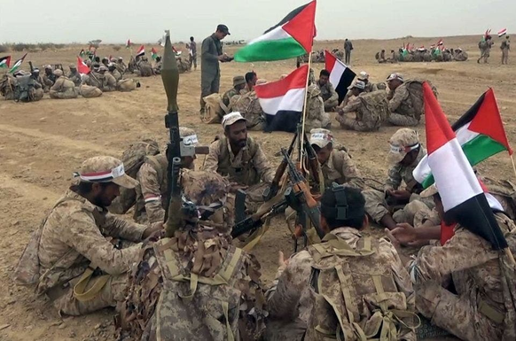 Combattants Houthis avec drapeau palestinien au Yémen.
