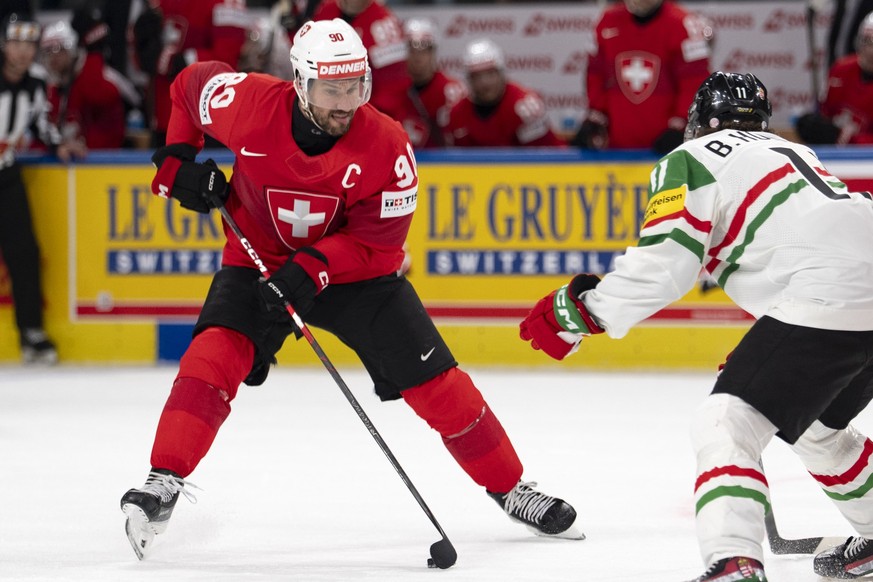 Switzerland's Roman Josi, left, in action against Hungary's Bence Horvath, right, during the 2026 IIHF Men's Ice Hockey World Championship preliminary round group A game between Switzer ...