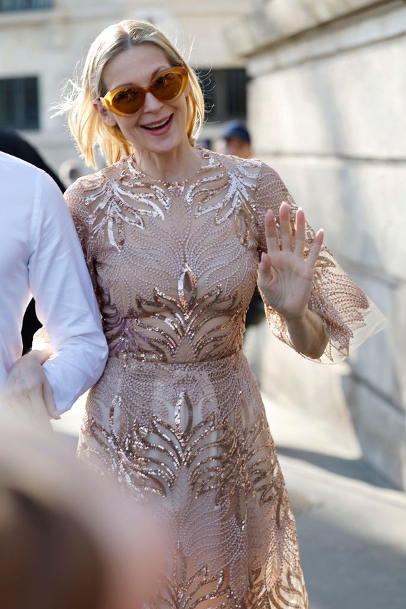 BERLIN, GERMANY - DECEMBER 10: Sonia Lyson is seen wearing black, oval-shaped Vehla sunglasses. Her outfit is cream-colored, consisting of a long, oversized faux fur coat that reaches her ankles. Unde ...