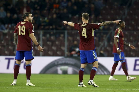 Servette&#039;s defender Yoan Severin, left, speaks with teammate Servette&#039;s defender Steve Rouiller, right, during the UEFA Conference League Play Off 1st leg soccer match between Switzerland&#0 ...